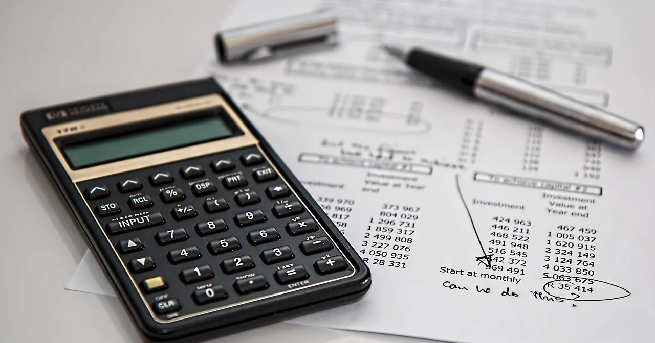 Calculator and pen on financial papers for calculating ROAS